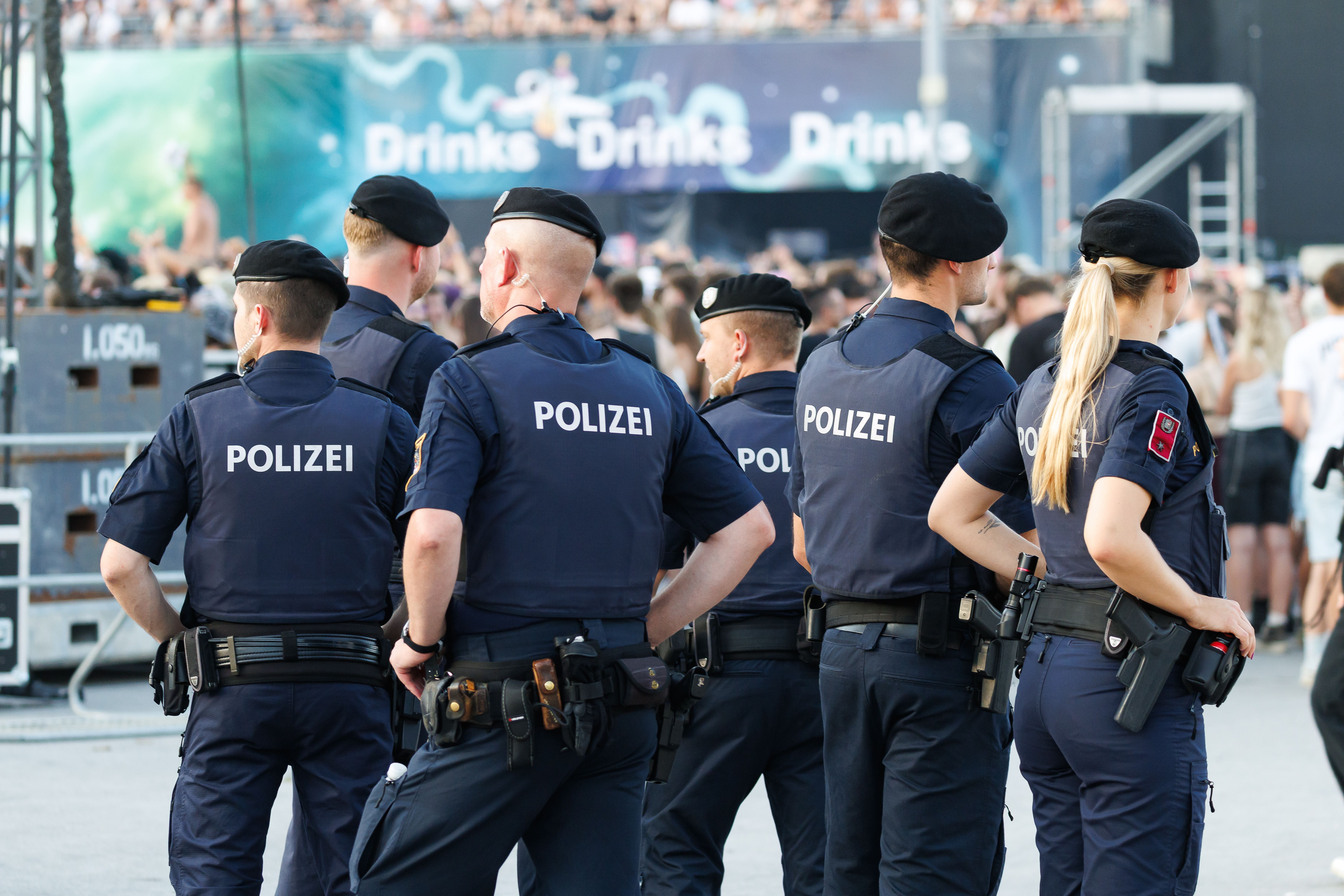 Mehrere Polizisten sichern ein Festivalgelände während eines Konzerts in St. Pölten.