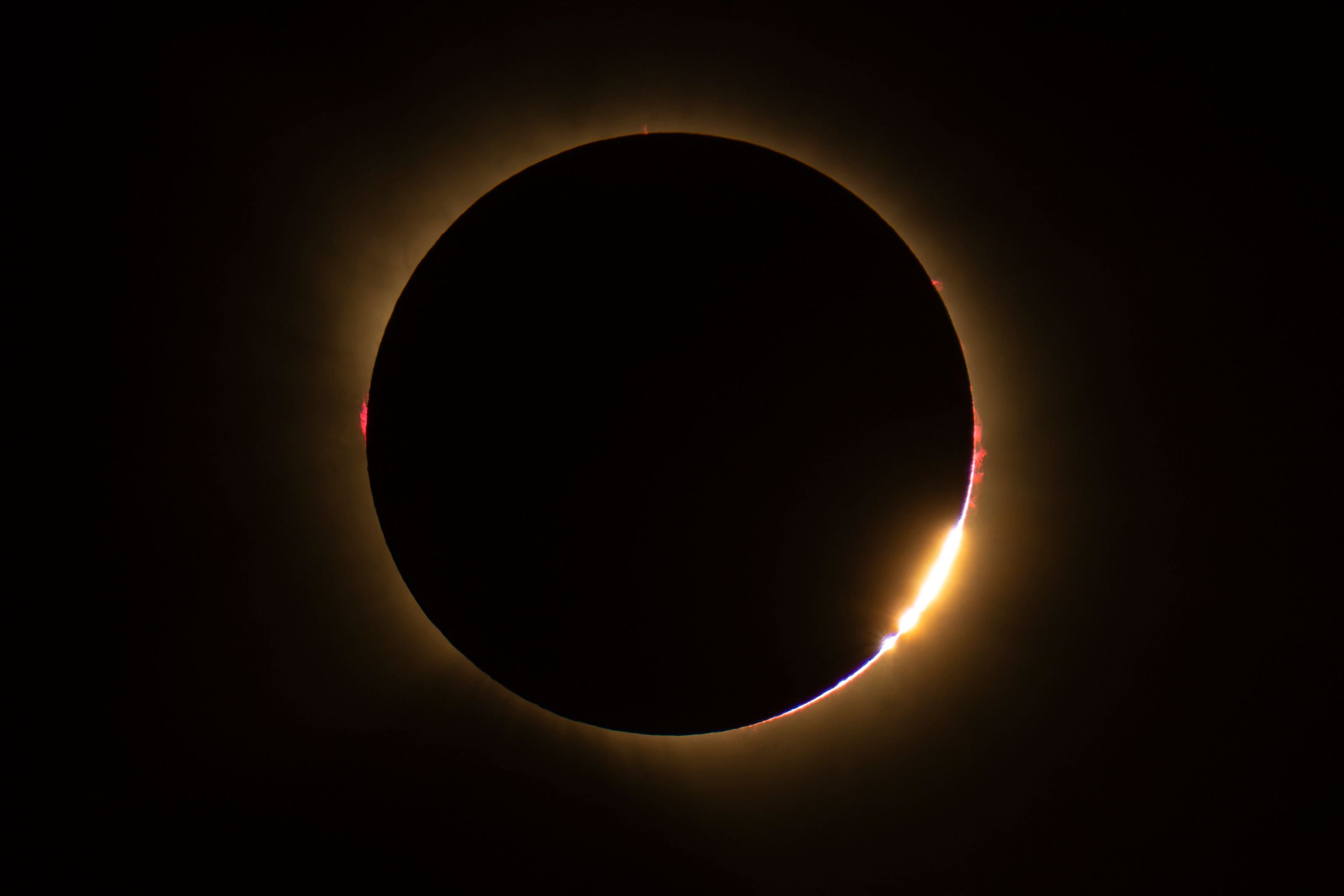 Eine totale Sonnenfinsternis mit Baily-Perlen-Effekt und hellem Licht am Sonnenrand von Nordspanien aus gesehen.