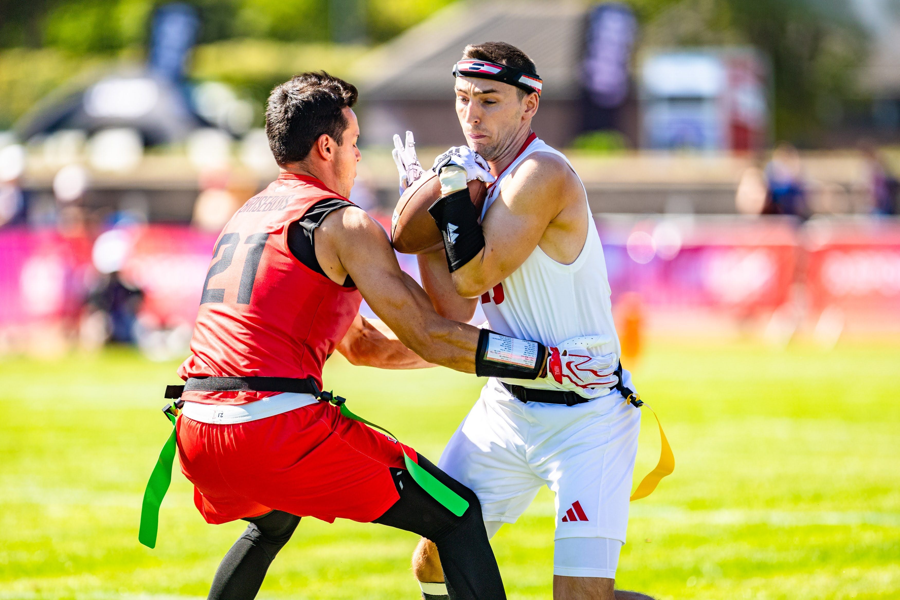 Zwei Flag-Football-Spieler aus Österreich und Kanada im Zweikampf um den Ball.