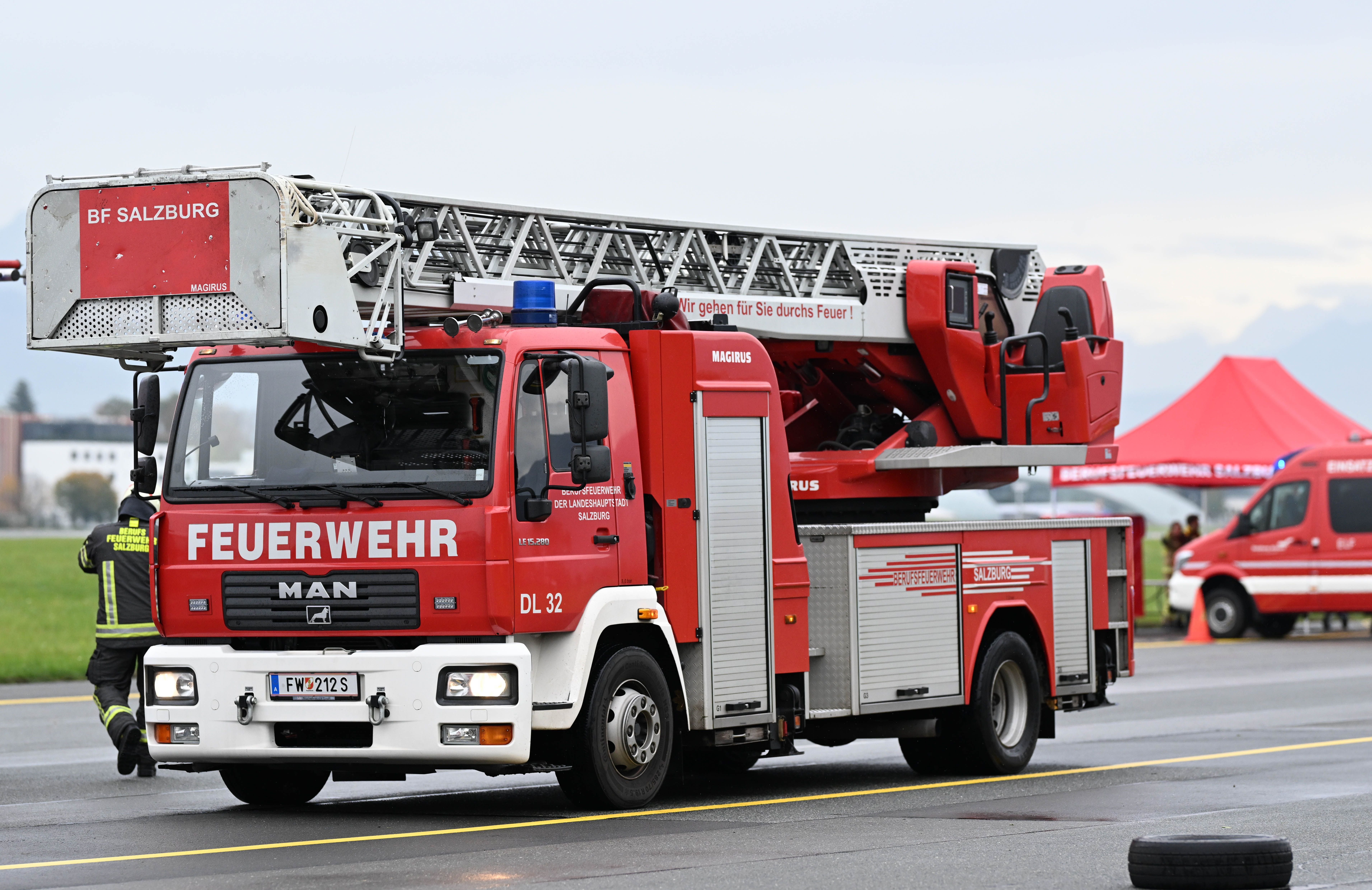 Ein Feuerwehrwagen mit Drehleiter im Einsatz bei einer Übung am Flughafen Salzburg.