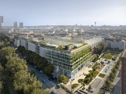 Modernes Bürogebäude mit begrünten Dachflächen und Fassaden in urbaner Umgebung in Wien.