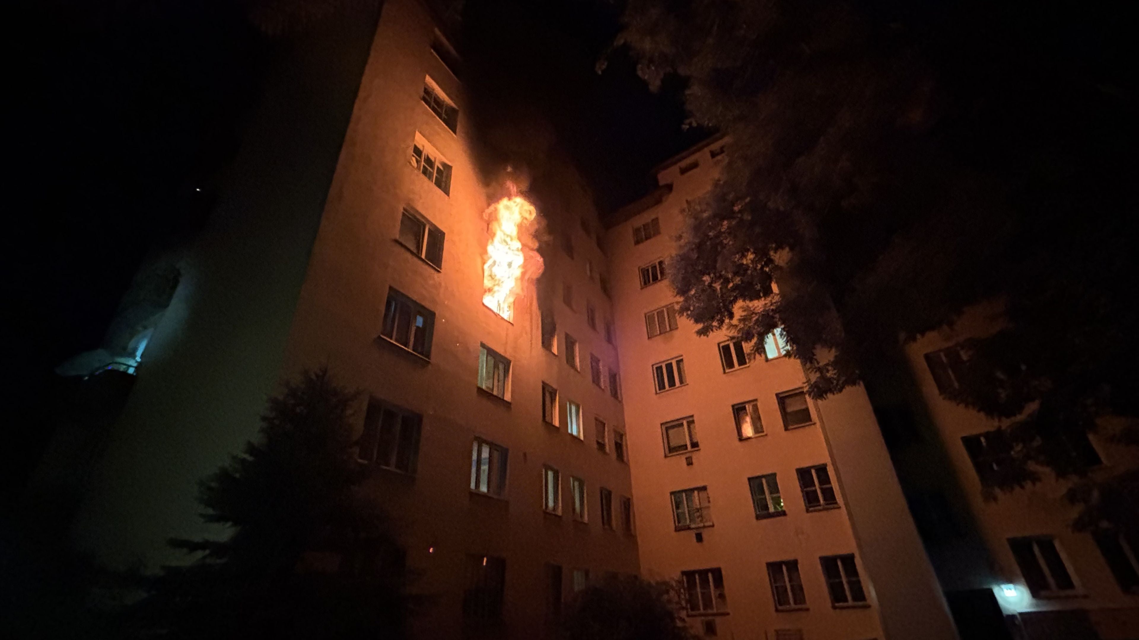Flammen schlagen nachts aus einem Fenster im dritten Stock eines Wohnhauses in Wien-Leopoldstadt.