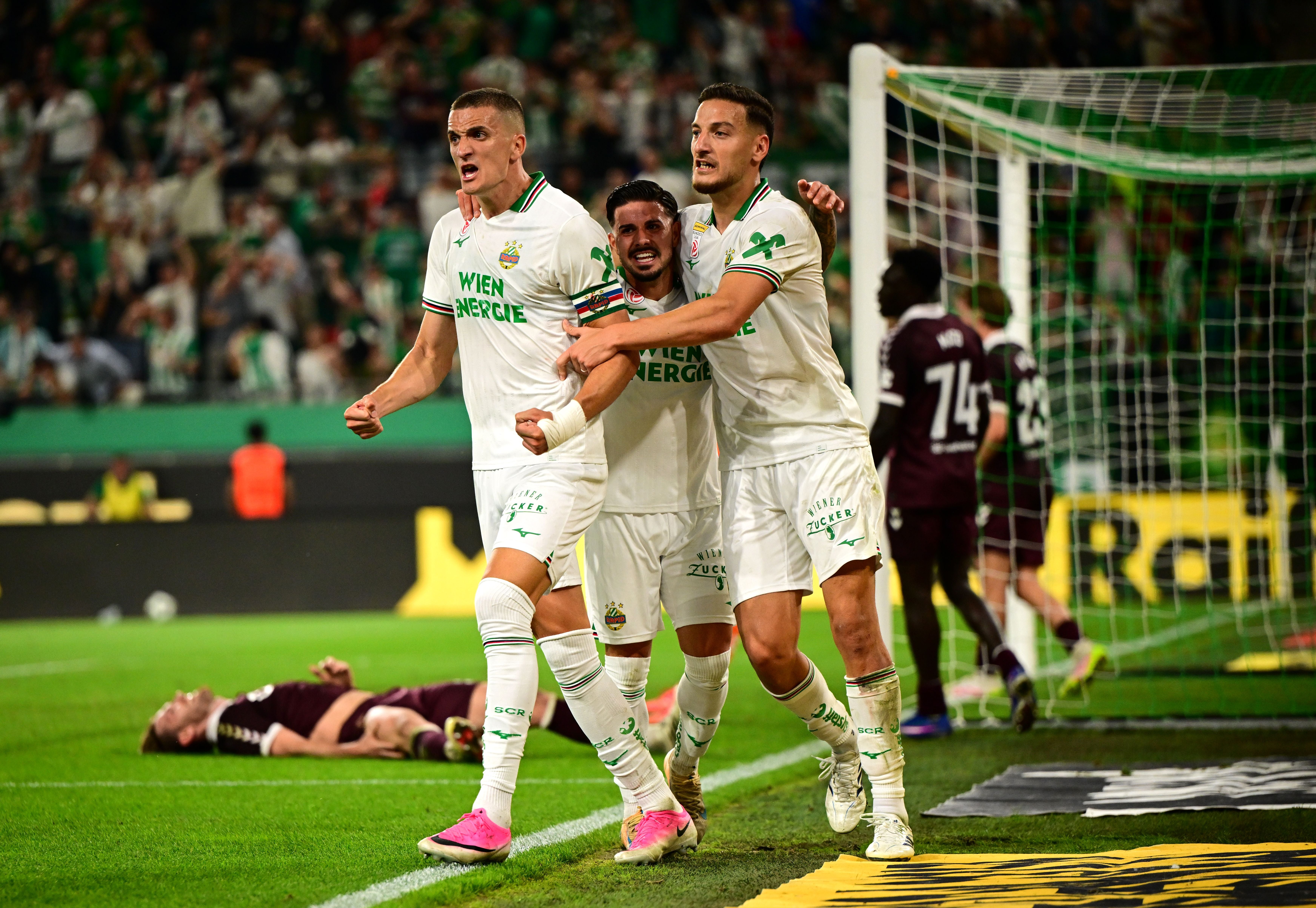 VIENNA, AUSTRIA - AUGUST 26: Nenad Cvetkovic of SK Rapid celebrates scoring his team’s second goal with teammates during the UEFA Conference League 2026/27 Play Off Round Second Leg match between SK Rapid and Heart of Midlothian at Weststadion on August 26, 2026 in Vienna, Austria. (Photo by Christian Bruna/Getty Images)