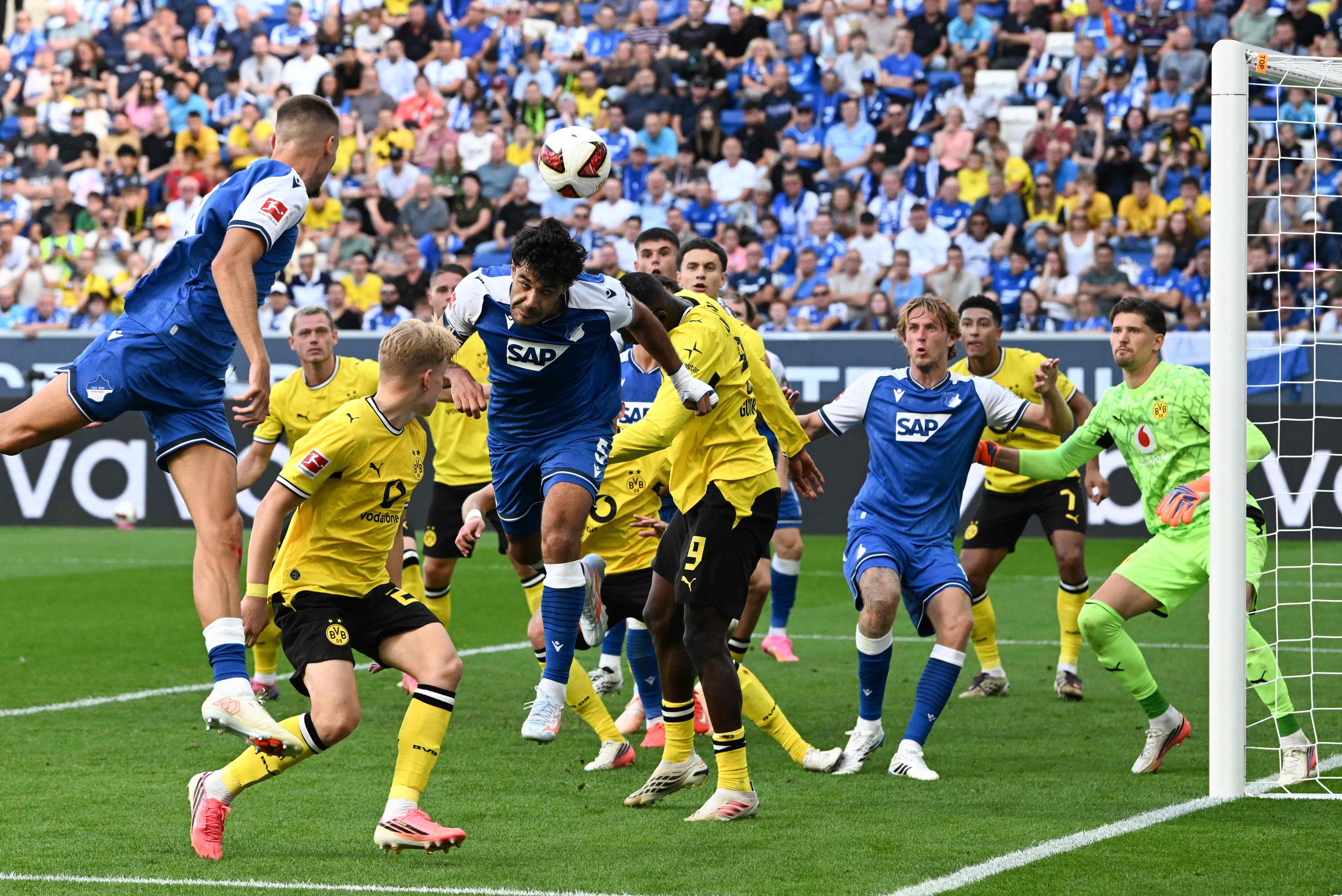 Mehrere Spieler kämpfen im Strafraum während eines Bundesliga-Fußballspiels um den Ball.