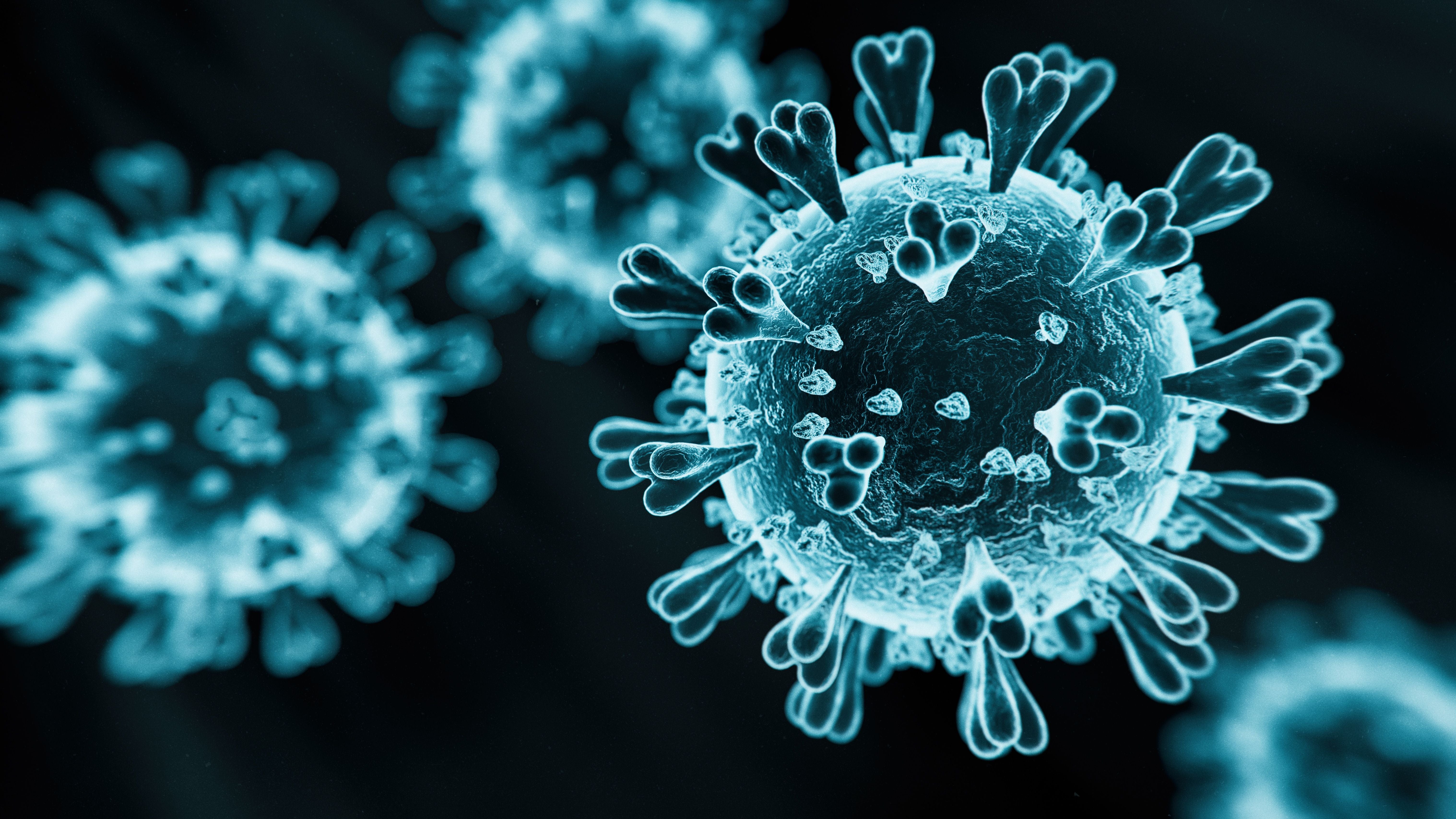 3D-Darstellung eines Coronavirus mit typischen Stachelproteinen auf dunklem Hintergrund.