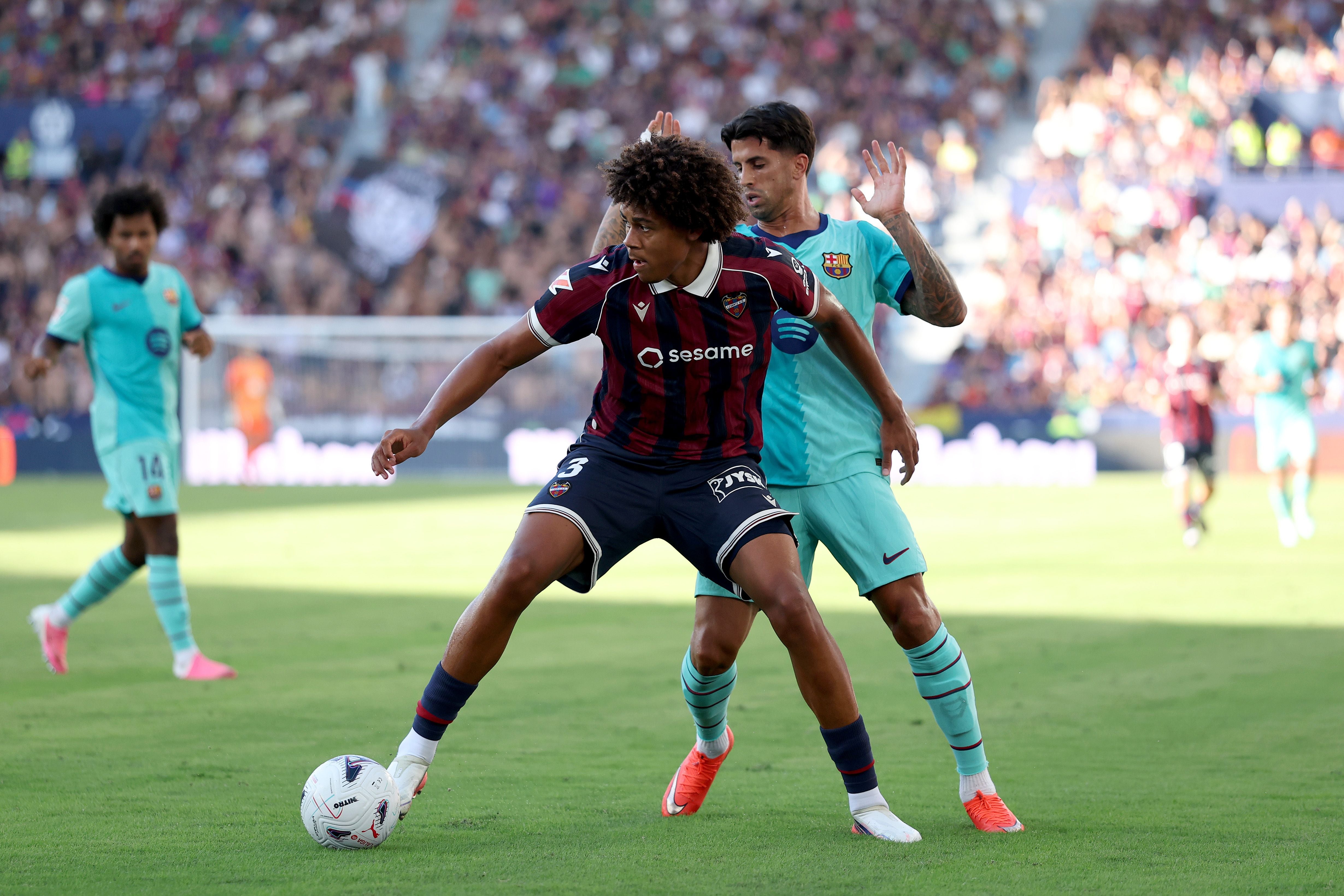 VALENCIA, SPAIN - SEPTEMBER 13: Ifeanyi Ndukwe of Levante UD cis challenged by Joao Cancelo of Barcelona during the LaLiga EA Sports 2026/27 match between Levante UD and FC Barcelona at Ciutat de Valencia on September 13, 2026 in Valencia, Spain. (Photo by Clive Brunskill/Getty Images)