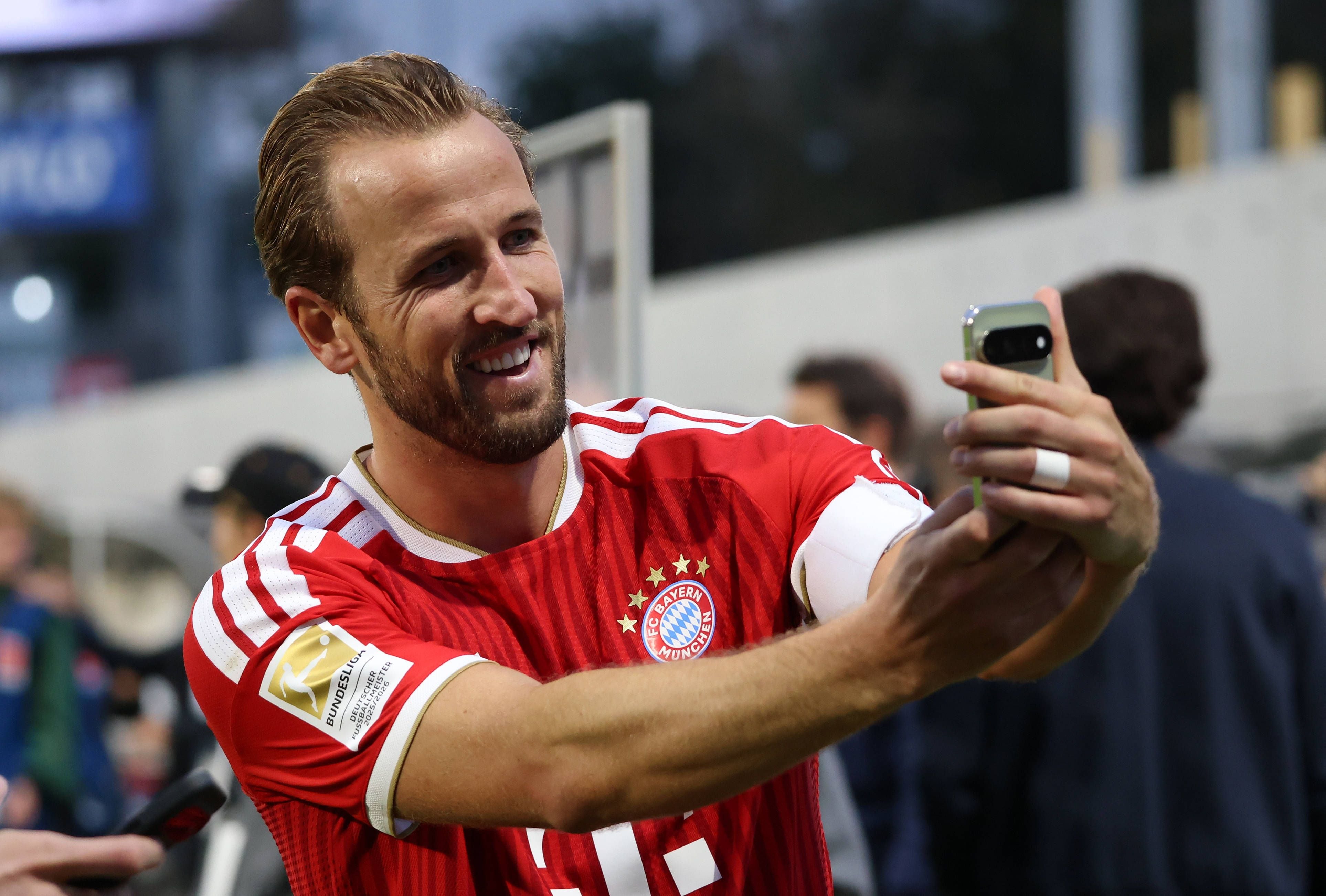 Ein Fußballspieler des FC Bayern München macht nach dem Spiel ein Selfie im Stadion.