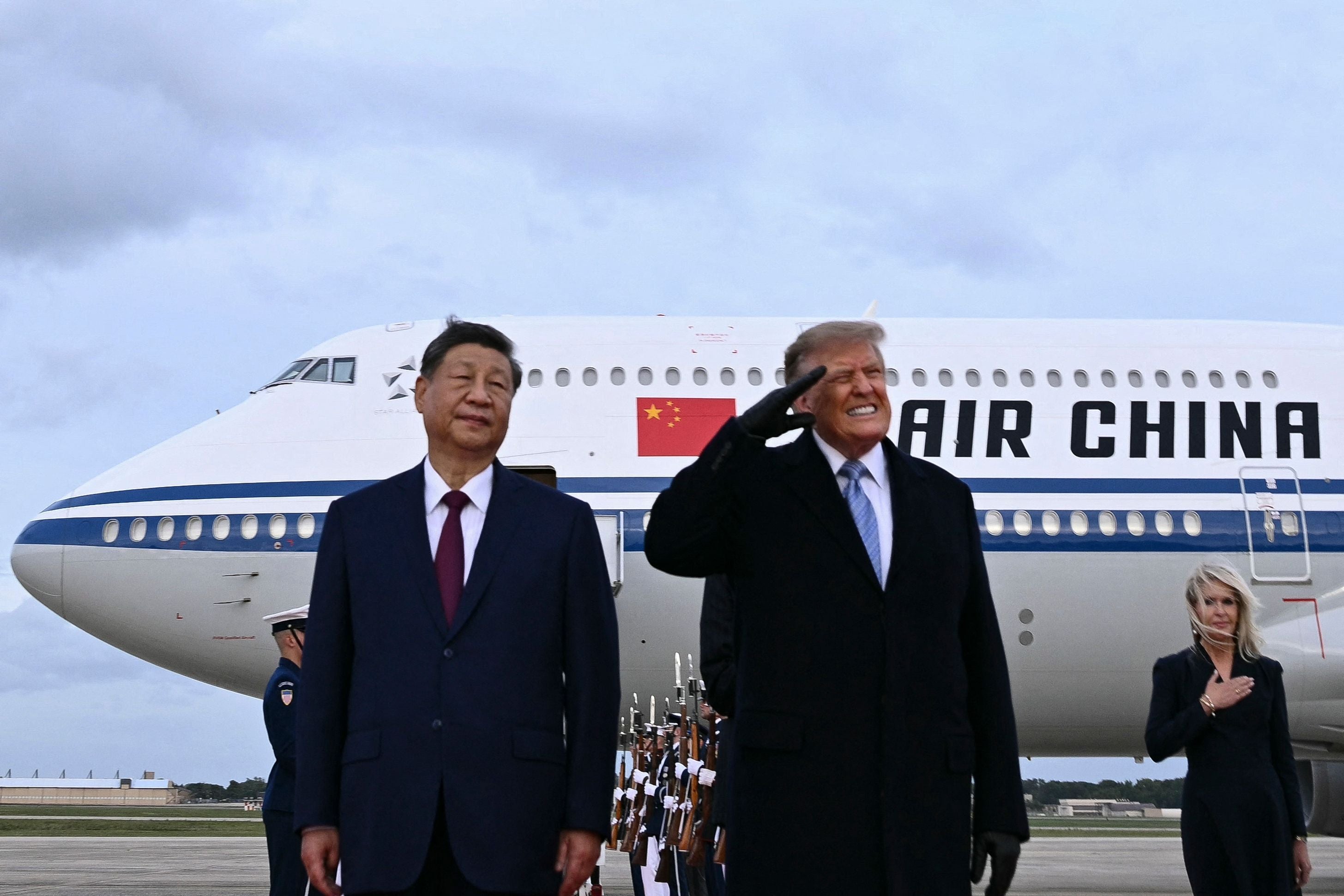 Donald Trump und Xi Jinping stehen vor einem Air-China-Flugzeug auf einem Flughafen.