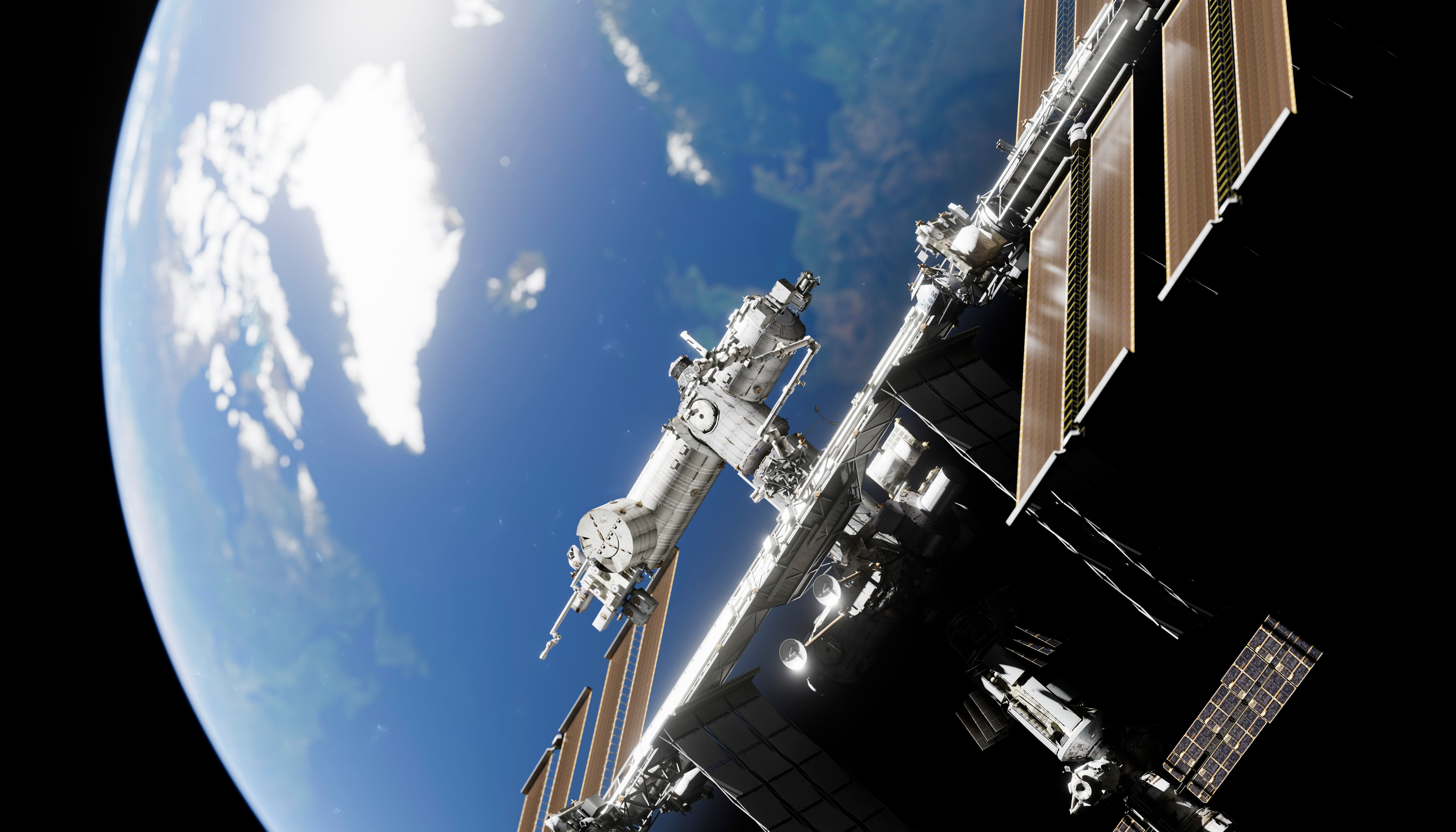 Die Internationale Raumstation schwebt über der Erde im Sonnenlicht im Weltraum.