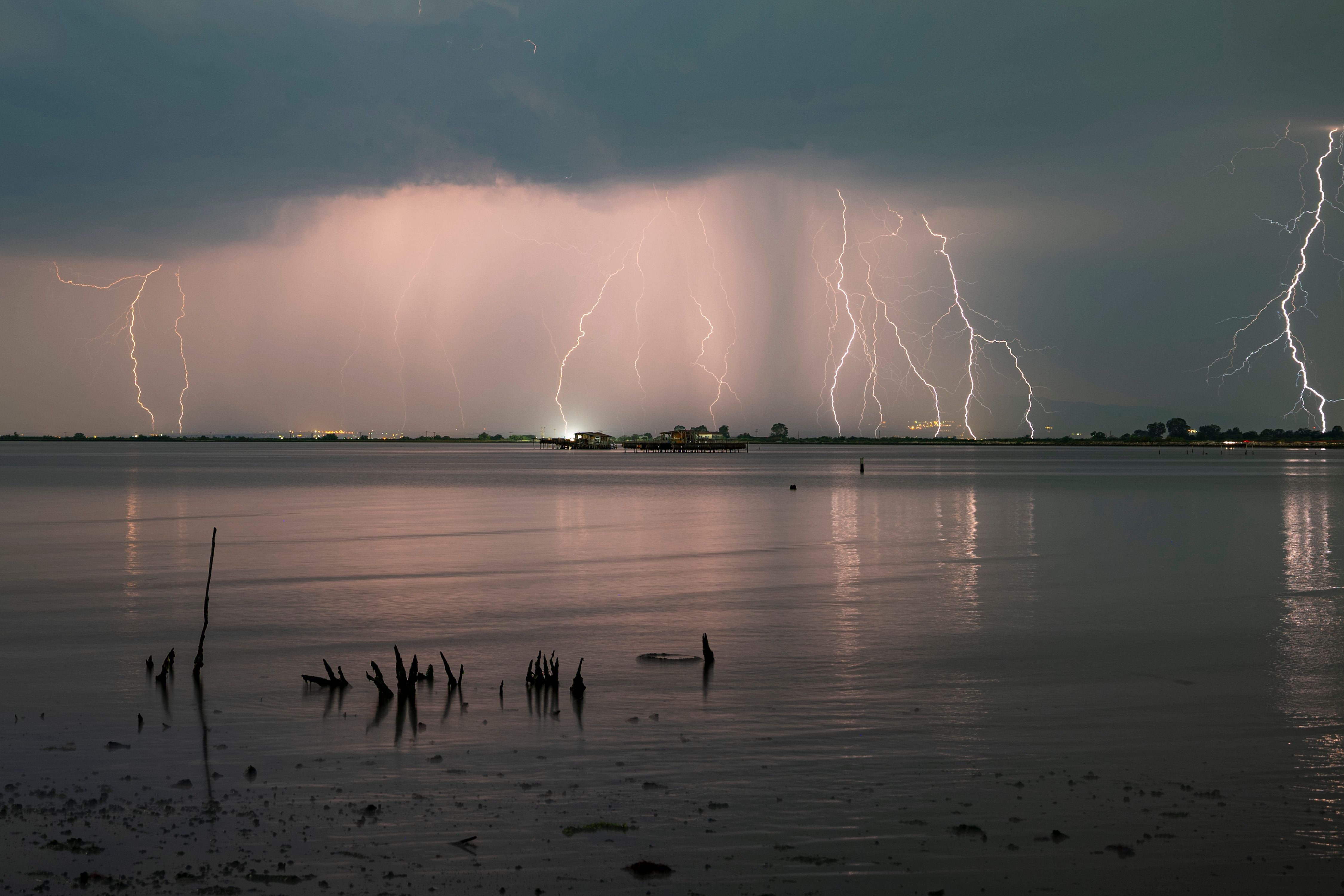 Mehrere Blitze erleuchten bei Nacht ein Gewitter über dem Meer bei Thessaloniki, Griechenland.