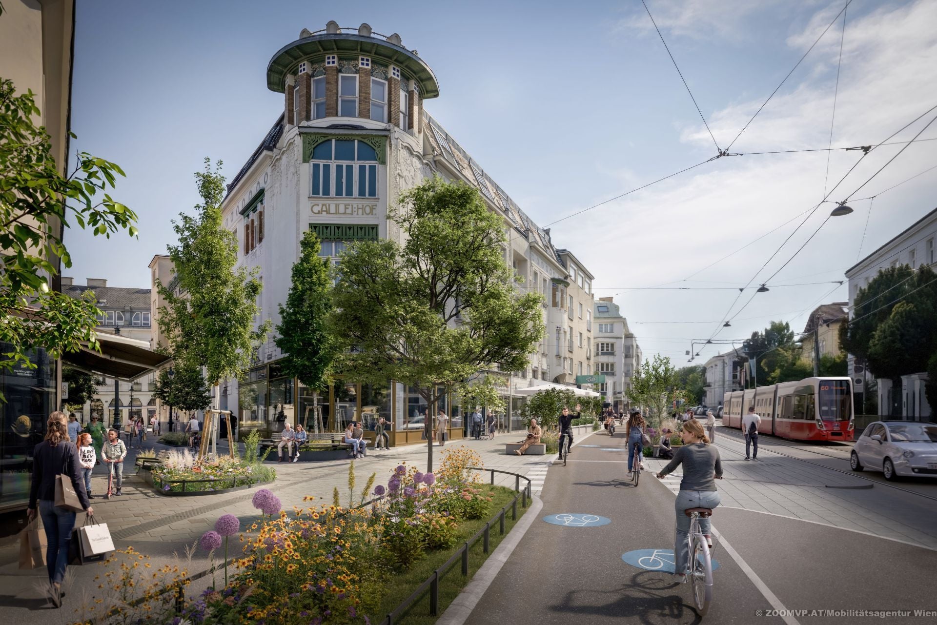 Belebte Lainzer Straße mit Radweg, Fußgängern, Straßenbahn, Blumenbeeten und begrünten Bereichen.