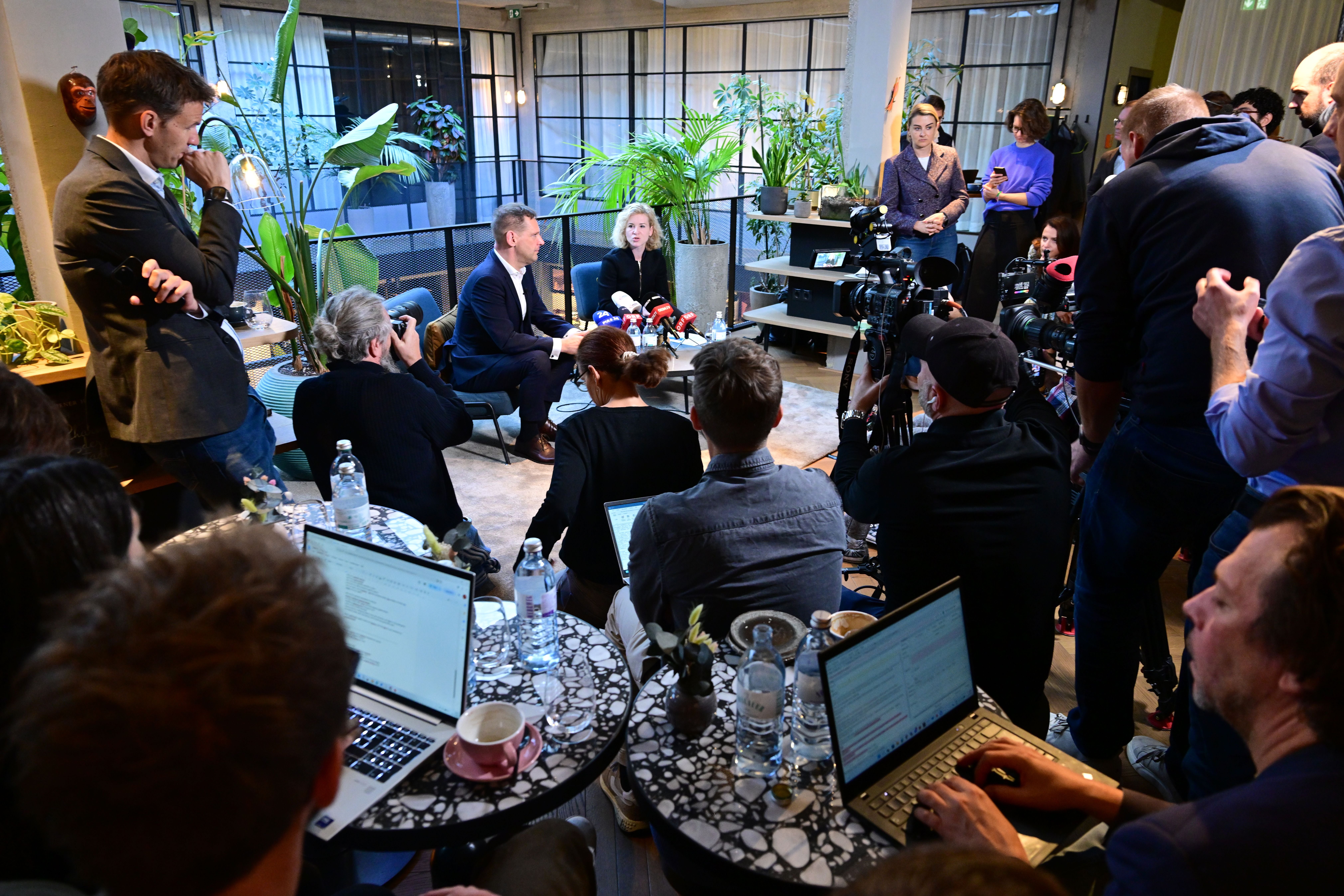 Pressegespräch mit Philip Kucher und Eva-Maria Holzleitner, umgeben von Journalisten und Kameras.