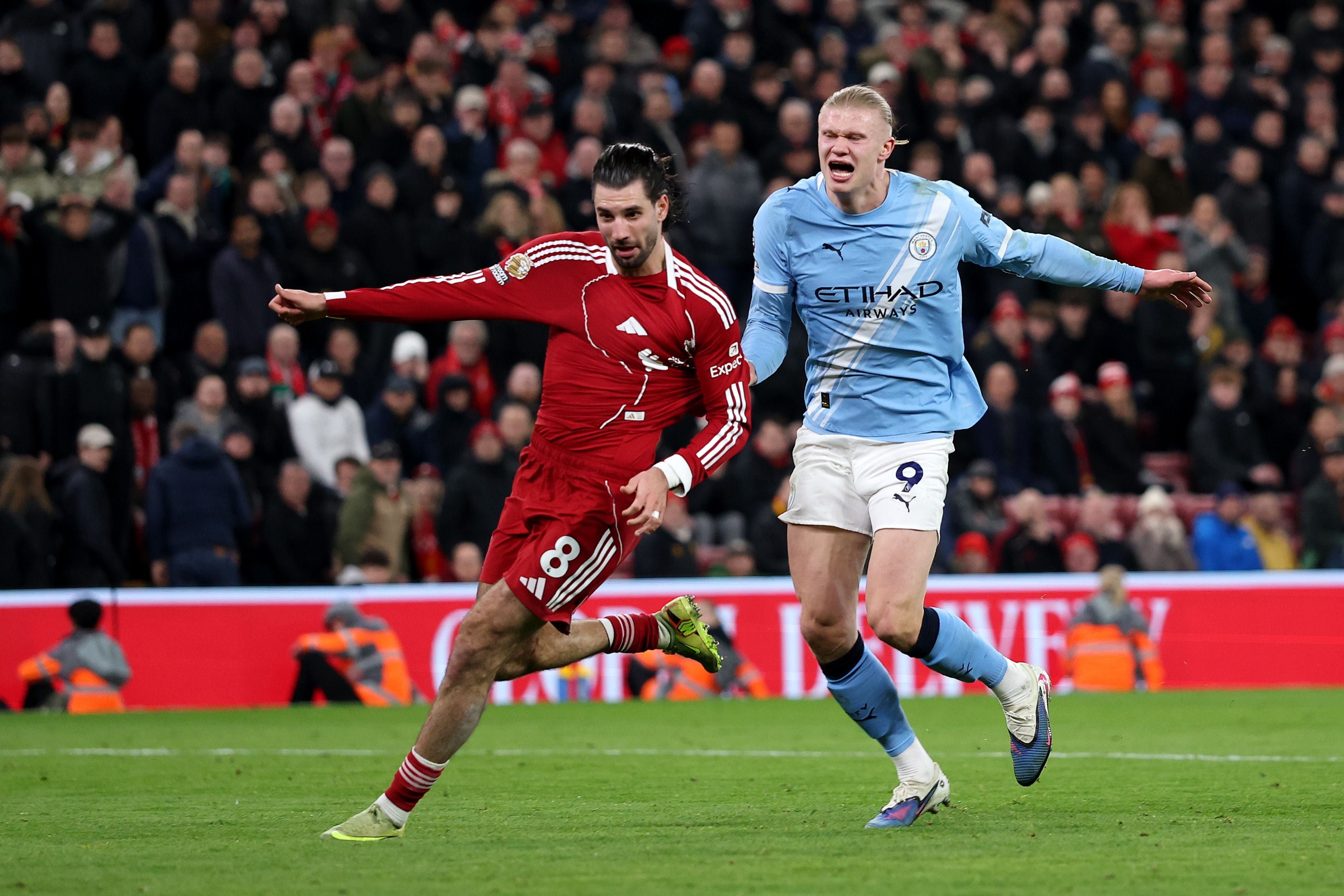 LIVERPOOL, ENGLAND - FEBRUARY 08: Dominik Szoboszlai of Liverpool fouls Erling Haaland of Manchester City leading to a red card following a VAR review during the Premier League match between Liverpool and Manchester City at Anfield on February 08, 2026 in Liverpool, England. (Photo by Michael Regan/Getty Images)