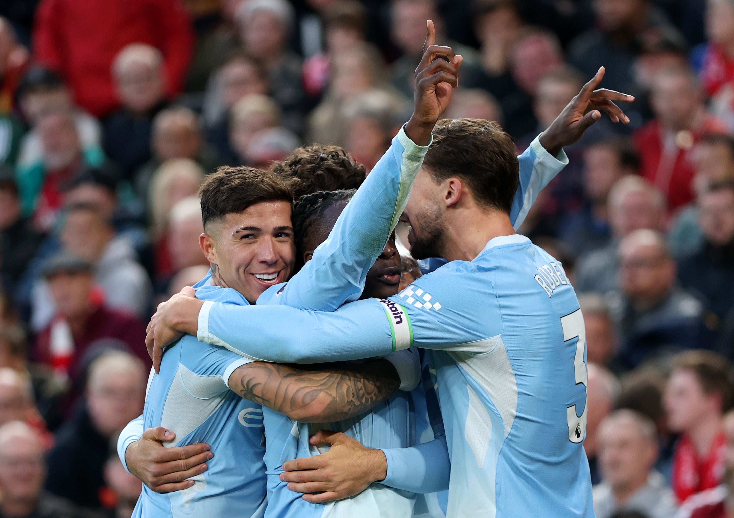LIVERPOOL, ENGLAND - OCTOBER 11: Jeremy Doku of Manchester City celebrates scoring his team’s second goal with Enzo Fernandez and Ruben Dias during the Premier League 2026/27 match between Liverpool FC and Manchester City at Anfield on October 11, 2026 in Liverpool, England. (Photo by Michael Regan/Getty Images)