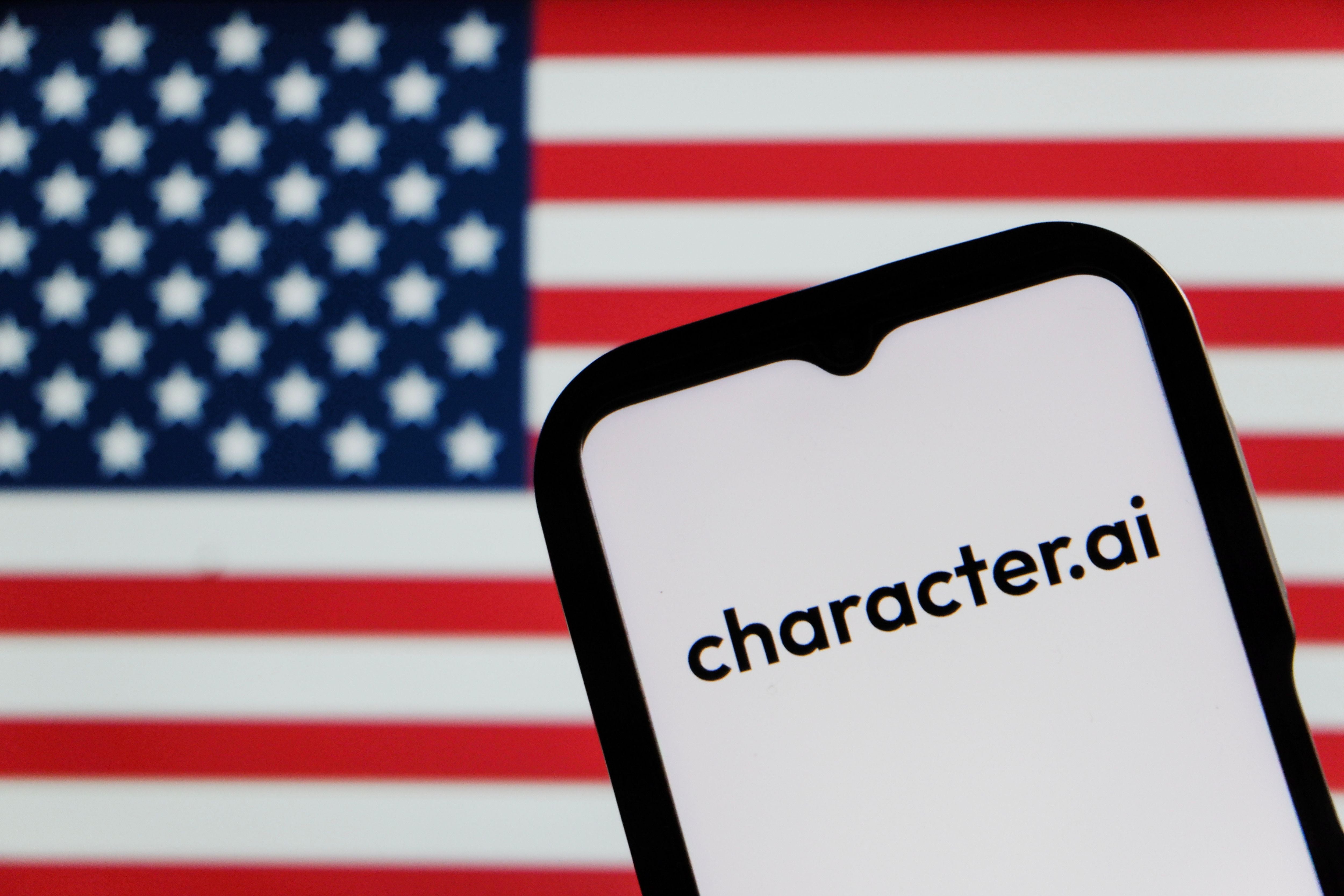 Smartphone mit Character.ai-Logo vor einer unscharfen US-Flagge im Hintergrund.