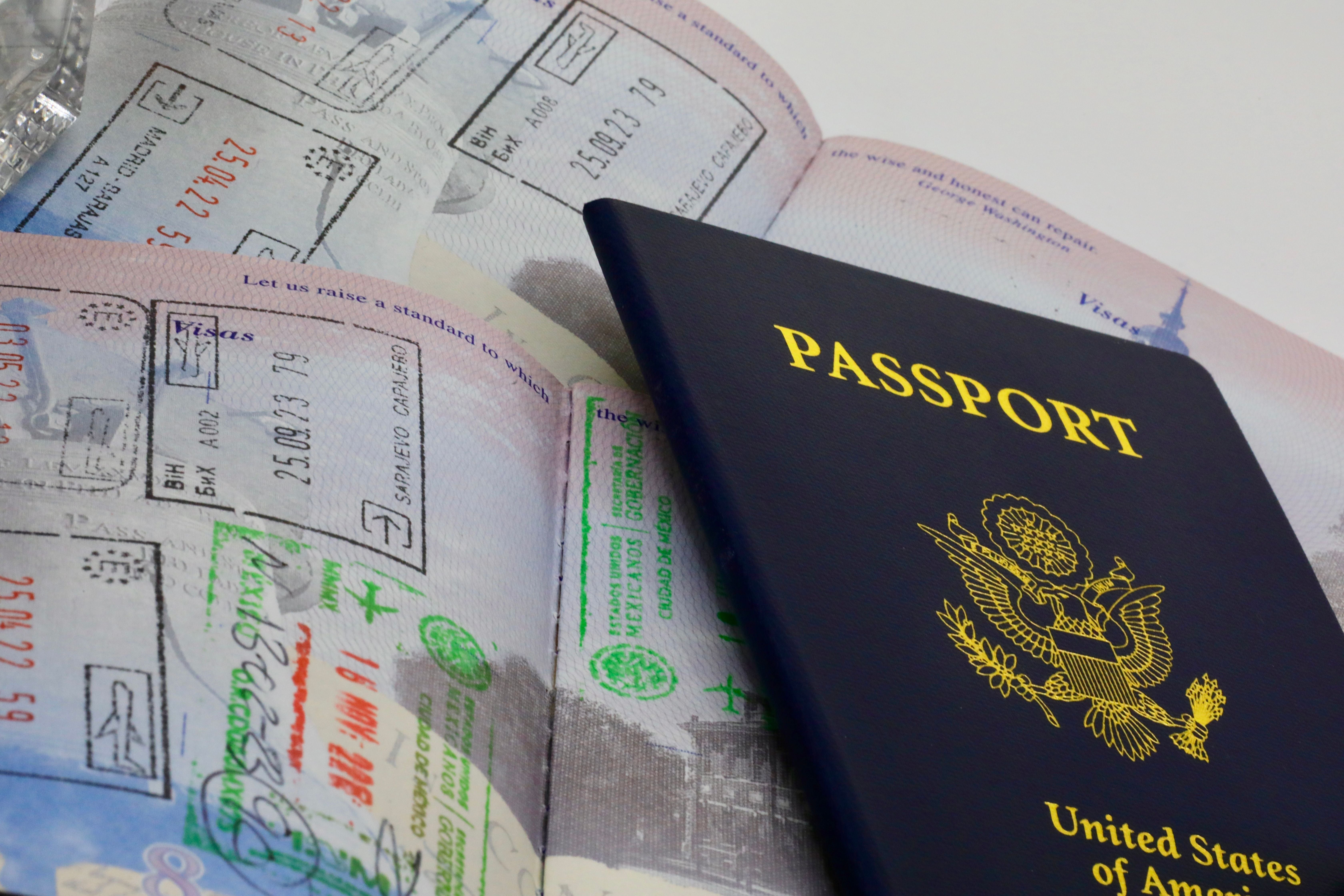 US-Pass mit Einreisestempeln und Visa in geöffnetem Reisepass.