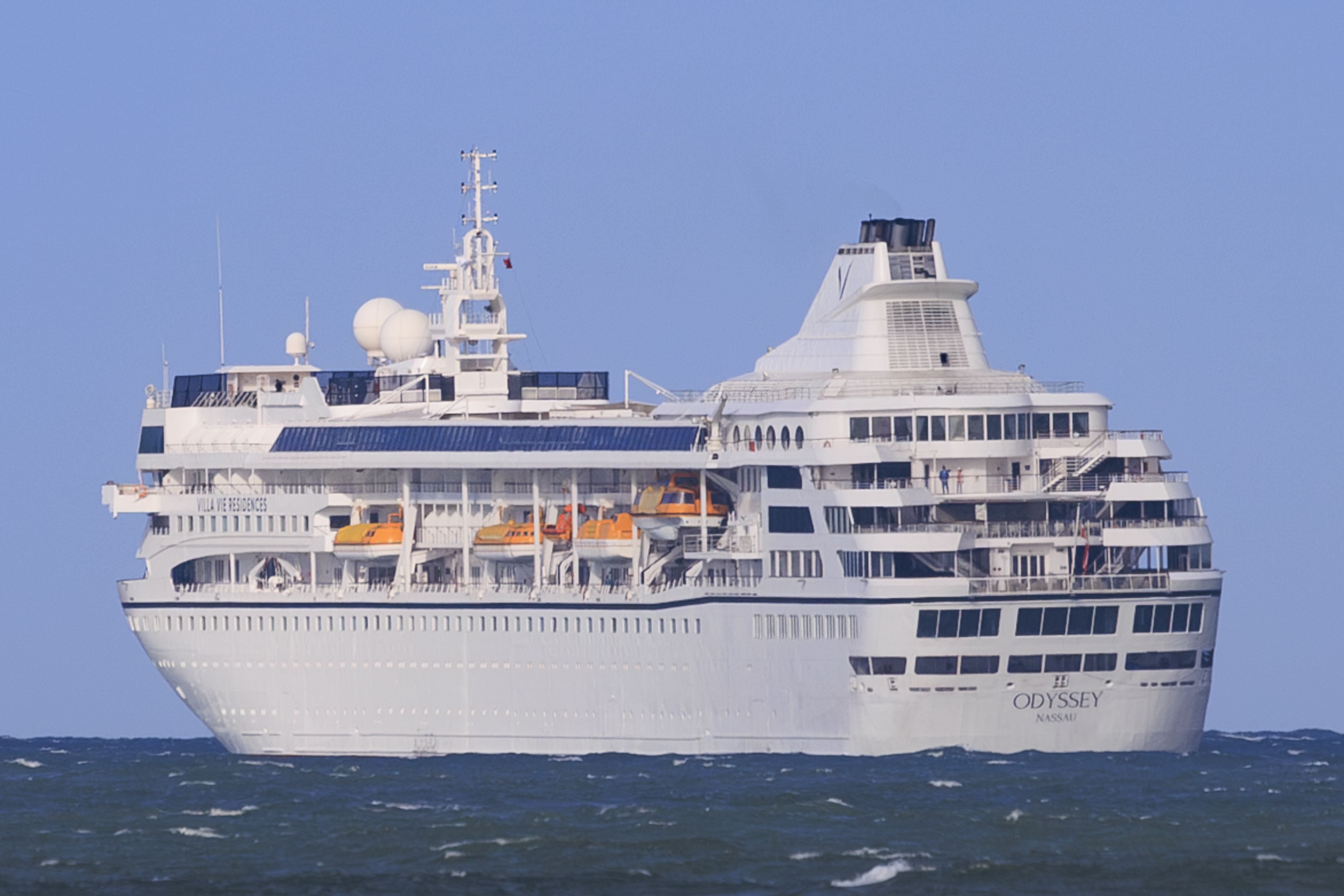 Das Kreuzfahrtschiff Villa Vie Odyssey fährt auf dem Meer vor blauem Himmel.
