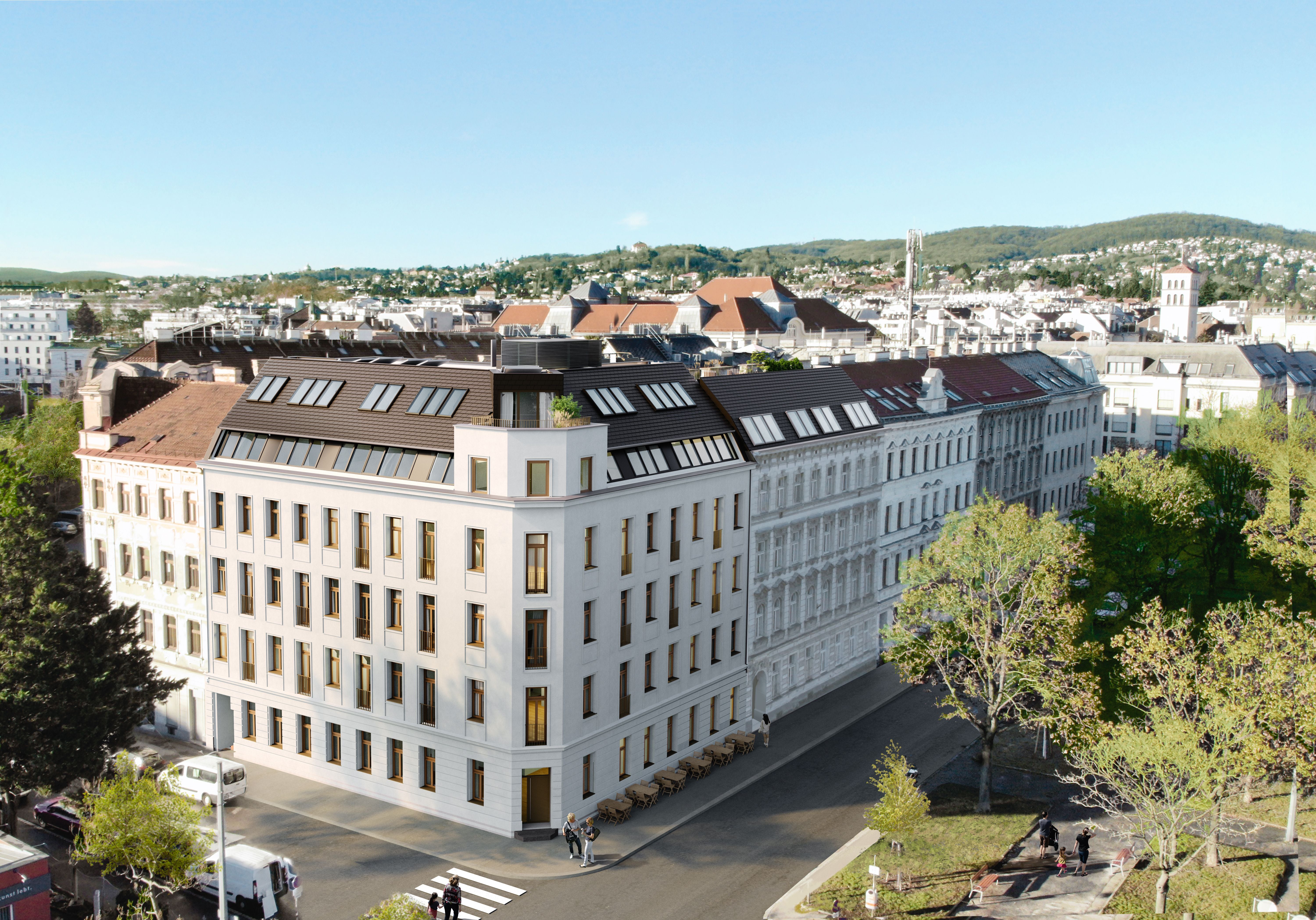 Modernisiertes weißes Eckgebäude mit großen Fenstern in einer urbanen Umgebung mit Bäumen.