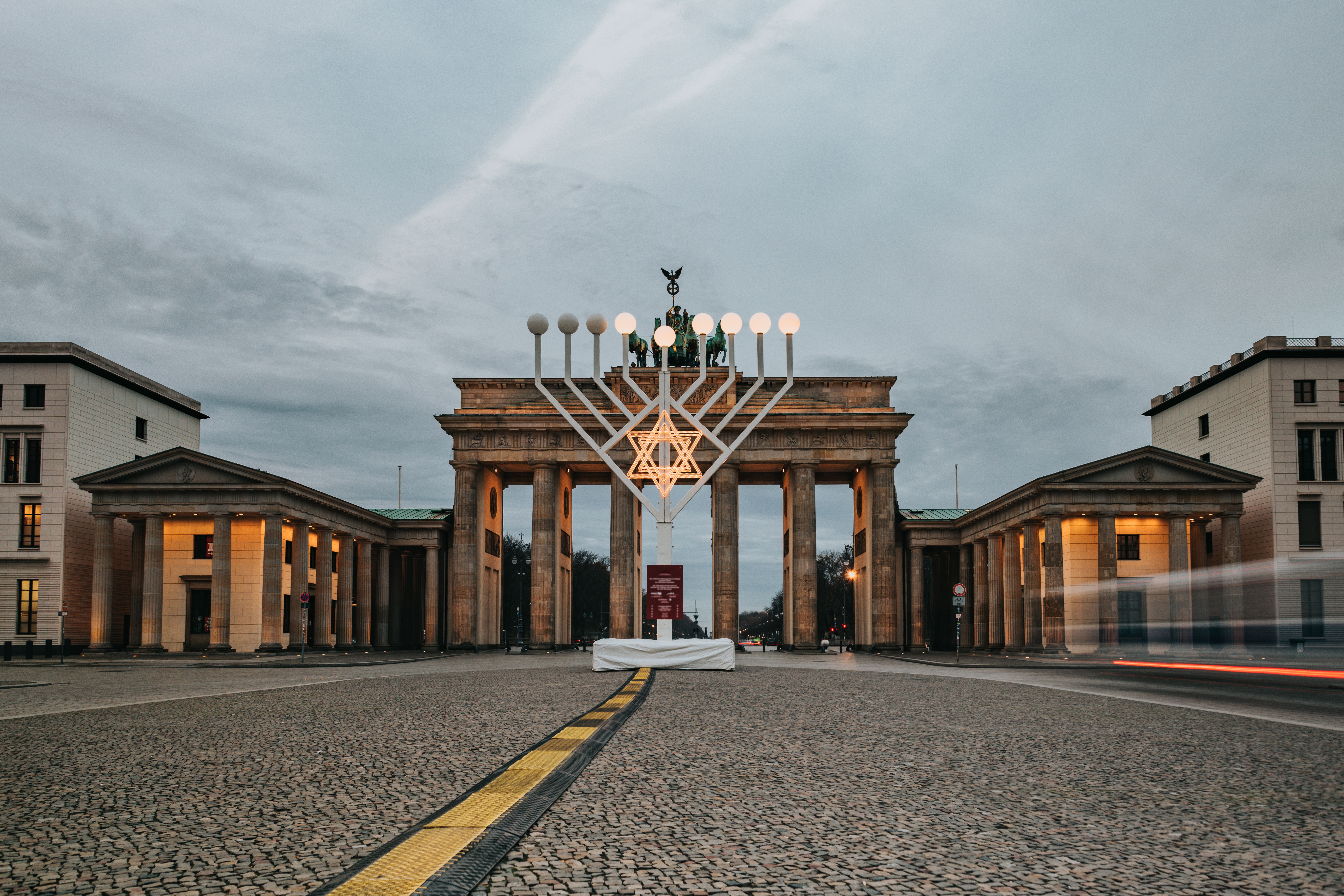 Beleuchtete Menora vor dem Brandenburger Tor in Berlin an einem Dezembermorgen.